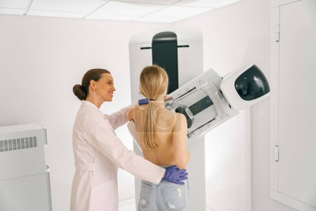 Woman doing mammogram x ray for breast cancer prevention screening at hospital