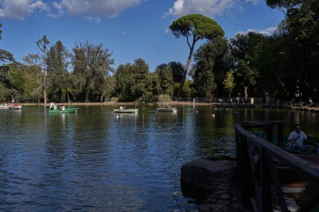 Rome, Italy - September 22, 2022 - visitors rowing their boats in the lake of the Villa Borghese gardens