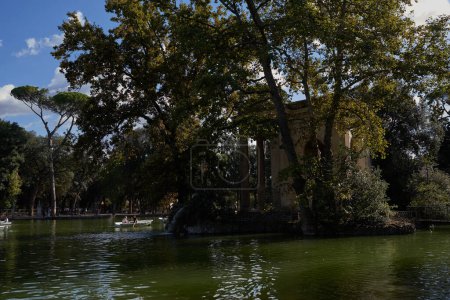 Photo for Rome, Italy - September 22, 2022 - visitors rowing their boats in the lake of the Villa Borghese gardens - Royalty Free Image