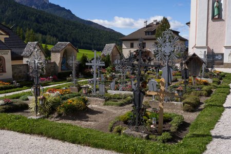 Photo for Sesto-Sexten, Italy - September 19, 2022 - The parish church of St. Peter and St. Paul with the beautiful cemetery with arcades in late summer - Royalty Free Image