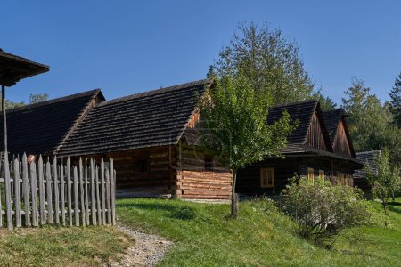 Photo for Roznov pod Radhostem, Czech Republic - September 28, 2023 - the Wallachian village - wooden houses in rural countryside on a sunny autumn day - Royalty Free Image