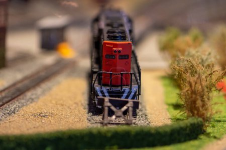 Photo for A mock-up of a toy diesel locomotive stands on a siding at a dead end, selective focus. - Royalty Free Image