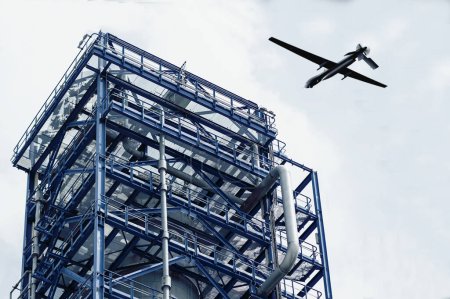Téléchargez les photos : Drone militaire sur tour industrielle de dépôt de pétrole, attaque de drone. - en image libre de droit
