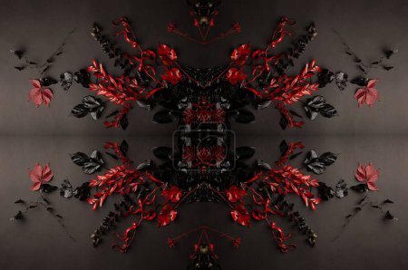 Téléchargez les photos : Pattern texture of red and black leaves on a black background. Red and black creative creative wallpaper. Texture for design. - en image libre de droit