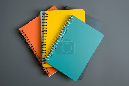 Colorful notebooks isolated on grey background