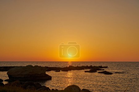 Photo for A colorful sunset on the rocky Mediterranean coast - Royalty Free Image