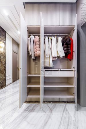 Photo for Modern built in wardrobe with closet. Assortment of fur coats - Royalty Free Image