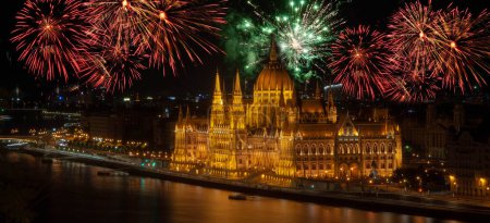 Photo for Night view of the Parliament in the city of Budapest in Hungary. fireworks display over parliament New Year celebrations in Budapest - Royalty Free Image
