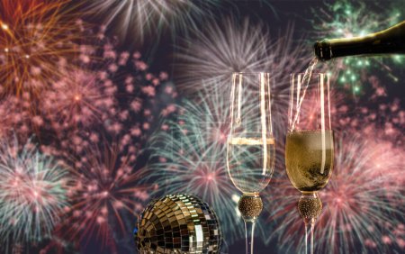 Photo for Happy New Year champagne glasses and fireworks celebration background - Royalty Free Image