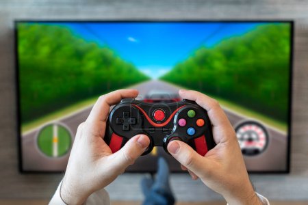 gaming gameplay tv. fun game on gamepad. game controller video console playing player holding. hobby playful enjoyment view concept. car racing simulator