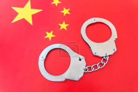 Photo for China flag and police handcuffs. The concept of observance of the law in country and protection from crime - Royalty Free Image