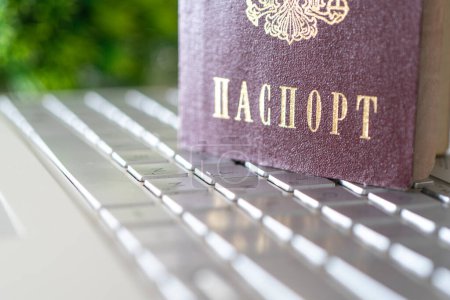 Photo for Passport of the Russian Federation on a gray laptop keyboard. Identification of the user on the Internet. Prohibition of access to the Internet without passport data. - Royalty Free Image