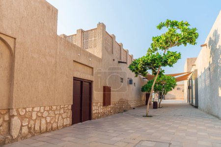 Photo for Old buildings in the Bastakia quarter, Dubai. The buildings are recreations of the old structures around Dubai Creek, and feature wind towers. Old Dubai no people. - Royalty Free Image