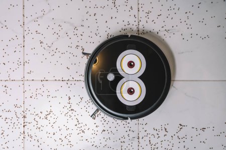 Photo for Robotic vacuum cleaner on laminate white tiled floor smart cleaning technology. garbage on the white tiled. top view - Royalty Free Image