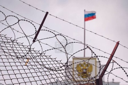 Photo for The concept of European and US sanctions pressure on the Russian Federation government. flag of the Russian Federation in barbed wire, sanctions and aggression of Russia. Russian prison - Royalty Free Image