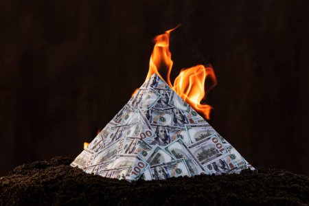 Photo for A global financial pyramid based on the dominance of the dollar. World management concept. conspiracy theory. the collapse of the dollar's financial system. Money is burning on a dark background. - Royalty Free Image