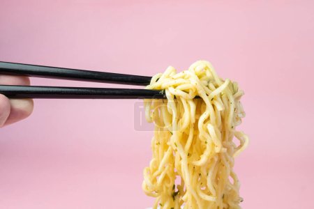 Photo for White bowl of noodles on an pink background, fast cheap food. Chinese instant noodles. Asian food. - Royalty Free Image