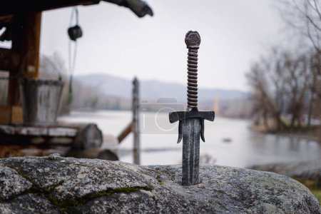 Foto de Famoso excalibur espada del rey Arturo atrapado en la roca. Armas afiladas de la leyenda Pro rey Arthur
. - Imagen libre de derechos