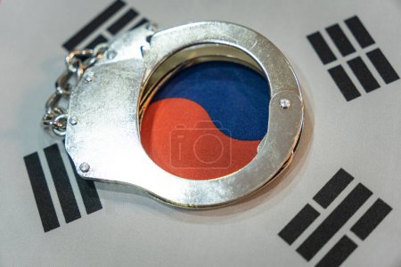 Photo for South korea flag and police handcuffs. The concept of observance of the law in country and protection from crime - Royalty Free Image