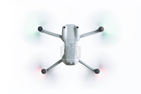 Photo for Flying drone with spinning propellers on a white background top view - Royalty Free Image