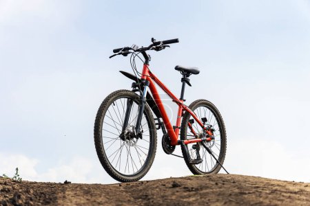 Foto de Bicicleta vintage en color naranja sobre fondo con cielo azul. Conducción todoterreno. - Imagen libre de derechos