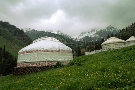 Photo for Kazakh guest yurt on background of mountains not far from Almaty in early autumn. A beautiful landscape with a traditional nomad house in the mountains of Almaty. - Royalty Free Image