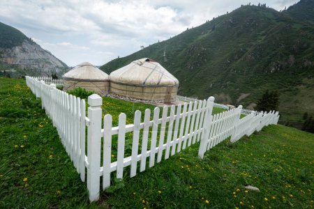Photo for Kazakh guest yurt on background of mountains not far from Almaty in early autumn. A beautiful landscape with a traditional nomad house in the mountains of Almaty. - Royalty Free Image