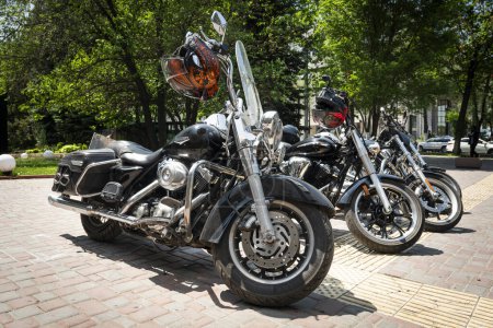 Photo for Bikes in a row. several large American Harley Davidson motorcycles stand in a row in the parking lot, Almaty, Kazakhstan. May 26, 2023 - Royalty Free Image