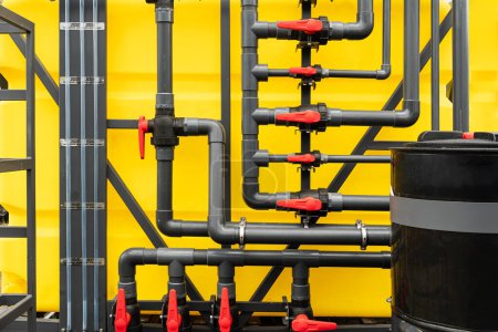 Photo for Lots of pipes and cranes on a yellow background. water supply system. - Royalty Free Image