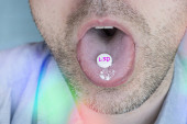 The guy swallows a pill with narcotic acid in close-up. Dependence on synthetic drugs. t-shirt #674535138