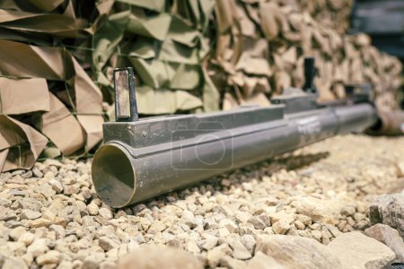 Photo for Military, Shooting RPG anti tank grenade launcher lying on the sand. war trophy. military supplies of heavy weapons. hand-held anti-tank grenade launcher - Royalty Free Image