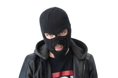 Photo for A thief in a black jacket. A man in a black balaclava with an evil expression on his face. An aggressive bandit isolated on a white background. The concept of crime or theft. - Royalty Free Image