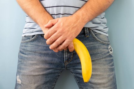 Téléchargez les photos : Banana out of mens jeans like men penis. potency concept - en image libre de droit