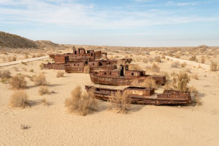Photo for Rusty ships at the ship graveyard in former Aral sea port town Moynaq (Mo ynoq or Muynak), Uzbekistan - Royalty Free Image