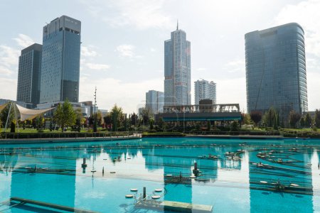 Awesome view of contemporary buildings reflected in pool of Tashkent City Park in Tashkent, Uzbekistan. park is a popular recreational gathering place among residents and tourists.