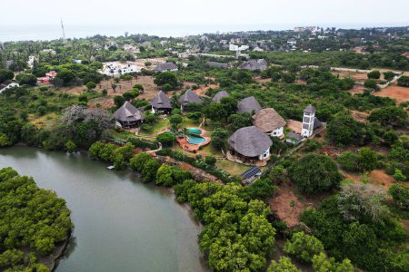 top view of the Congo River among the jungle and houses in the forest.