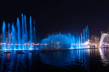 Téléchargez les photos : Spectacle de fontaine musicale. La fontaine de Sharjah est l'une des plus grandes fontaines de la région. Fontaine colorée dansante au bord de l'eau d'Al Majaz, Sharjah - en image libre de droit