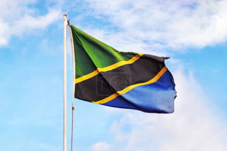 Tanzania flag on sky background. Close up waving flag of Tanzania. Concept of Tanzanian.