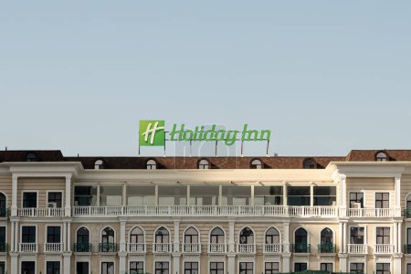 Photo for Tashkent, Uzbekistan - October 27, 2023: Close-up of the Holiday Inn logo atop on of their hotels, on a sunny day. - Royalty Free Image