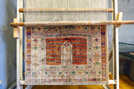 Photo for A demonstration of carpet making on a loom in State Museum of Applied Arts of Uzbekistan. October 28th. 2023 Tashkent, Uzbekistan. - Royalty Free Image