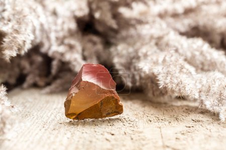 Photo for Beautiful Sample of Red and Orange Flint Rock over Wooden Background - Royalty Free Image