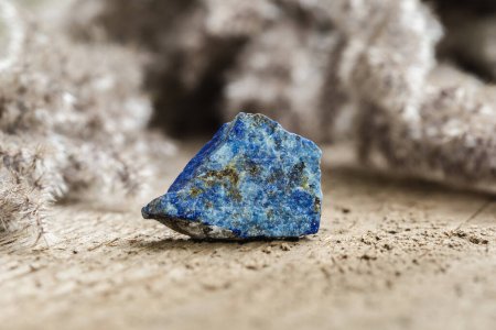 Photo for Piece of Raw Uncut, Blue Lazurite Mineral Stone Specimen on Wooden Background - Royalty Free Image