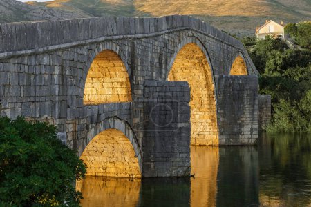 Photo for Trebinje, Old Stone Arslanagic Bridge on Trebisnica River on Sunset, Bosnia and Herzegovina - Royalty Free Image