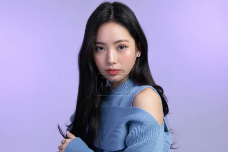 beautiful young Korean Asian woman portrait studio photo in winter skin beauty and cosmetics concept, resting face and hand motion