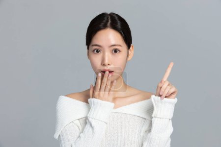 beautiful young Korean Asian woman portrait studio photo in winter skin beauty and cosmetics concept, surprising