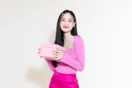 vintage y2k pink retro concept photo of korean asian cute woman holding gift boxes
