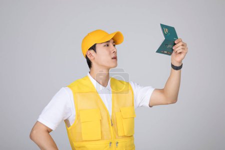 millennials and gen z, korean asian young man holding a bankbook