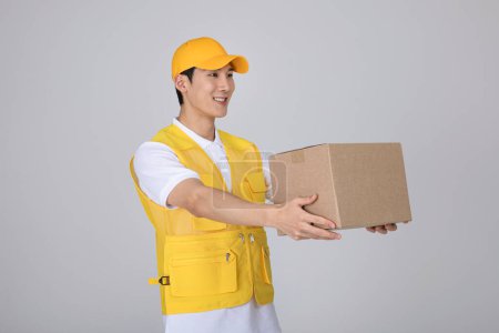 millennials and gen z, korean asian young man holding a parcel