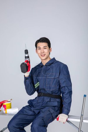 millennials and gen z, korean asian young man, site staff with drill