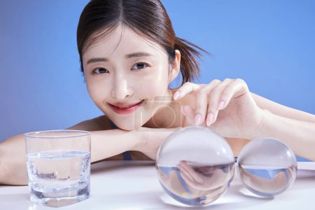 beauty concept photo of korean asain beautiful woman touching a crystal and smiling, studio background